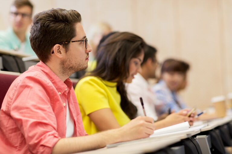 group of students with notebooks in lecture hall